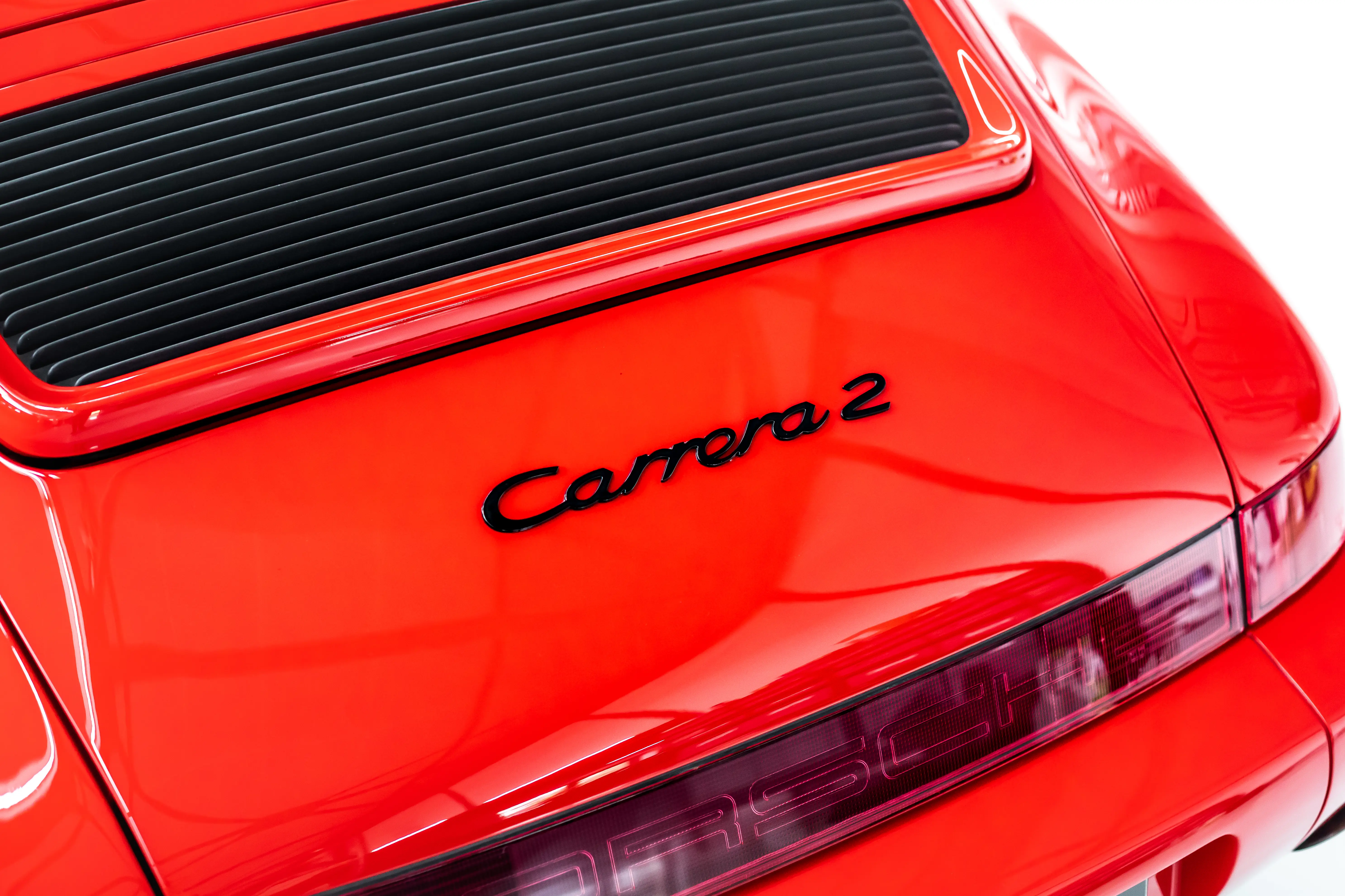 Carrera 2 Schriftzug am Heck des Porsche 964 – Detailaufnahme in Guards Red